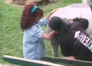 Redhead touching horse's private parts